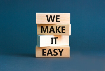 We make it easy symbol. Concept words We make it easy on wooden cubes. Beautiful grey table grey...
