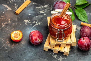 plum jam nd fresh plums on a wooden background. banner, menu, recipe place for text