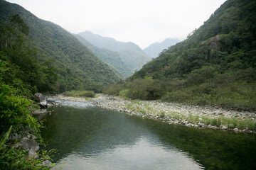 Hiking from Santa Teresa Hidroeléctrica to Aguas Calientes to reach Machupichu. Path following the train tracks with several hikers.