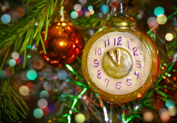 Christmas toy in the form of a clock on a festive tree