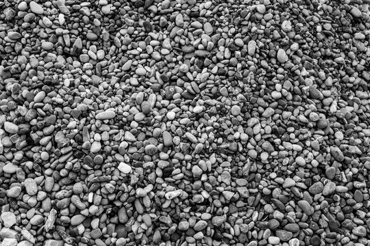 Background from beach pebbles, top view. Pebble texture for a poster, calendar, post, screensaver, wallpaper, postcard, banner, cover, website. High quality photography