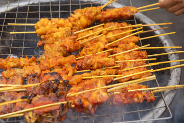 Thai street food. Barbecue roast in temple fair, and night local markets in Thailand. Retail shops