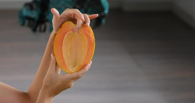 Half of papaya fruit on hand. Fragrant tropical fruit pulp. Sweet fresh papaw, raw vegan food. papaw pawpaw mountains Vasconcellea pubescens of South America, India, Myanmar, Thailand power of nature