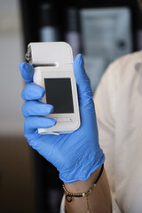 Hands holding special dermatology equipment system, hair loss and trichology concept. Analyzing Hair With Analysis System Digital Trichoscope. Close-up