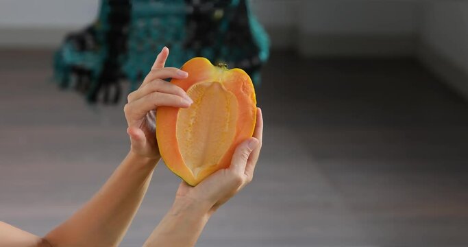 Half of papaya fruit on hand. Fragrant tropical fruit pulp. Sweet fresh papaw, raw vegan food. papaw pawpaw mountains Vasconcellea pubescens of South America, India, Myanmar, Thailand power of nature
