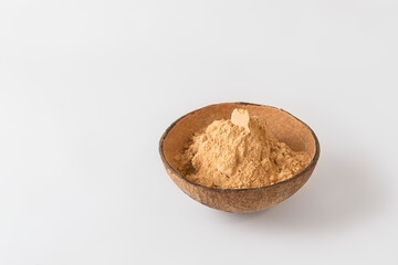 Organic root powder in a bowl on white background with copy space