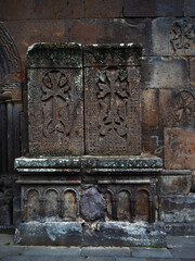 Armenian khachkars at the wall of an ancient monastery. Stone steles with carvings, a national...
