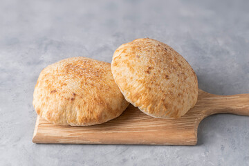 Pita bread on wooden board on neutral background. Georgian cuisine. Spanish food. National cuisine. Traditional dish