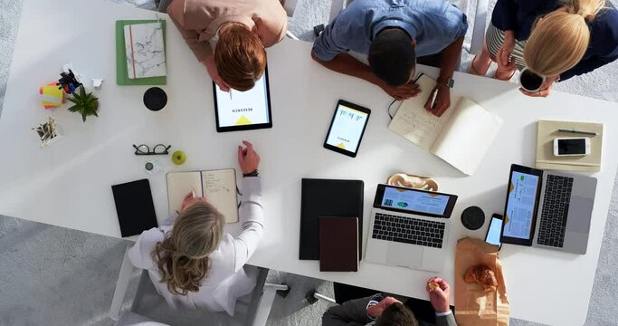 Technology, planning and business people in a meeting at the office in collaboration for company strategy plan. Top view of corporate team with digital tablet, laptop and paperwork working on project
