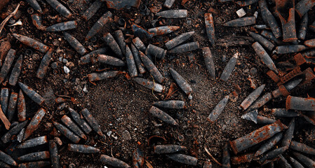 Burnt ammunition, bullets and casings after the fire. Burned arsenal of weapons, fire in the armory. Military theme background. militaristic wallpaper, the backside of guns