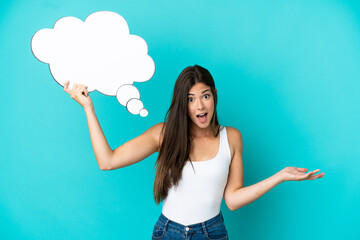 Young Brazilian woman isolated on blue background holding a thinking speech bubble and with sad expression