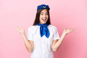 Airplane stewardess Brazilian woman isolated on pink background with shocked facial expression
