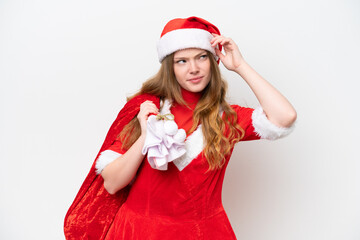 Young caucasian woman with Christmas dress holding Christmas sack isolated on white background having doubts and with confuse face expression