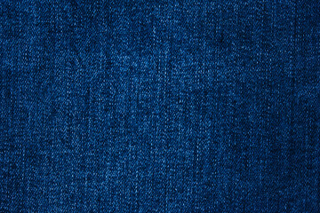 Stylish denim background. Close-up of the fabric of blue women's jeans