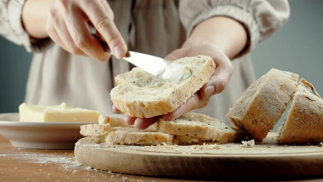 spreading butter on bread. sourdough bread knife Smearing butter