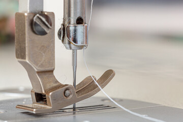 Sewing machine needle with thread and fabric