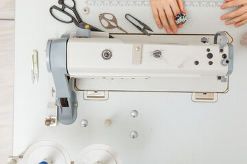 Top view sewing machine with sewing tools, scissors, thread