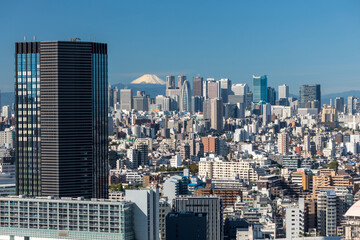 View of Tokyo skyline and Mt. Fuji. Skyscrapers in Shinjuku with latest landmark Tokyu Kabukicho...
