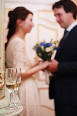 Portrait of emotional lovers of brides indoor.Bride and groom kisses tenderly . Emotional photo of a couple in love on the wedding day.