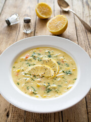 Lemon creamy soup on wooden table
