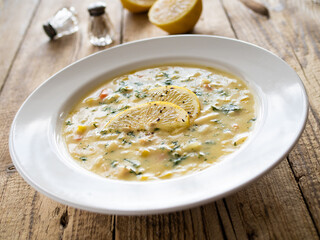 Lemon creamy soup on wooden table
