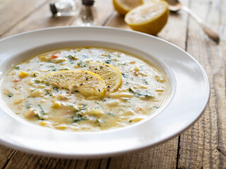 Lemon creamy soup on wooden table
