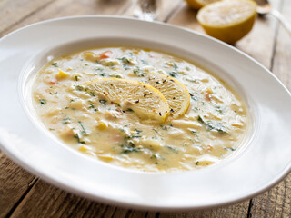 Lemon creamy soup on wooden table
