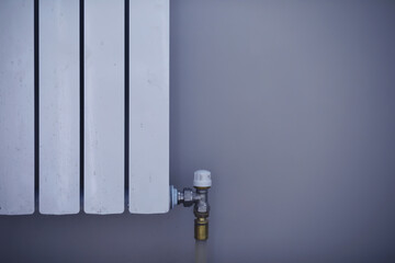 White modern aluminum radiator battery for hot water heating, on the background of a wall in the...