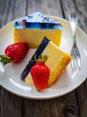 Cheesecake with fruits on wooden table