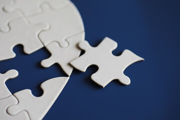 Clean puzzle elements on the background. Empty puzzle piece on the table. Teamwork concept.