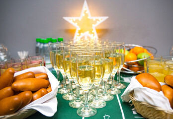 Festive table. Russian pies, soft drinks, juices, fruits and champagne in glasses.
