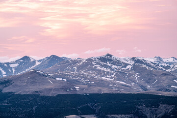 Crimson sunset sky with snow on the mountains