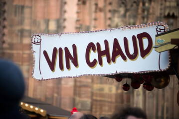 Closeup of mulled wine sign at the christmas market, traduction of vin chaud in french