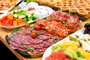 range of sausage cuts (chorizo, salami) on the snack table