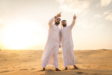 Arab men wearing typical middle eastern clothing in the desert