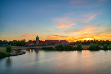 Caldecotte lake old windmill at sunset