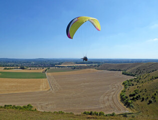 Yellow tandem Paraglider flying at Mere, Wiltshire
