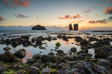 Fototapeta na wymiar Amazing sunset at the beach of Mosteiros with its islets, Azores Sao Miguel island, Portugal. Sunset landscape over the sea at the coasts on a beautiful summer evening. Seascape.
