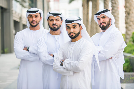 Group of arab businessmen wearing emirates kandora in Dubai - Business people meeting outoors in the UAE