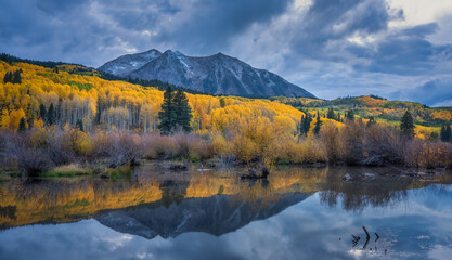 Fototapeta na wymiar Autumn blue hour colors in the Colorado Rocky Mountains - near Crested Butte on scenic Gunnison County Road 12 through the Kebler Pass - Beaver Pond