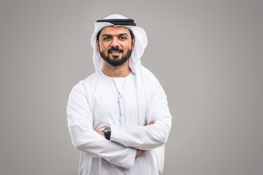 Handsome Arab Man Wearing Traditional Emirate Clothing Portrait In Studio - Middle Eastern Businessman Isolated On Cut-out Gray Background