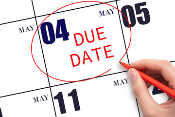 Hand writing text DUE DATE on calendar date May 4 and circling it. Payment due date