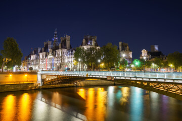 City hall of Paris and Pont d'Arcole bridge at night in. France