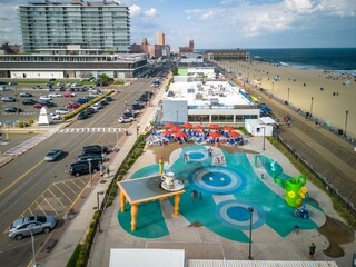 Fototapeta premium Drone of a building in Asbury Park Beach Boardwalk street New Jersey with parked cars