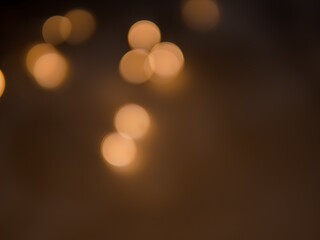 Golden and dark brown round bokeh lights festive background