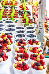 Big variety of small fruits at farmers' market