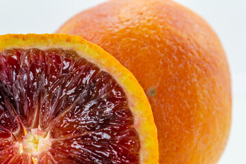 Close-up view of a blood orange slice on a white background