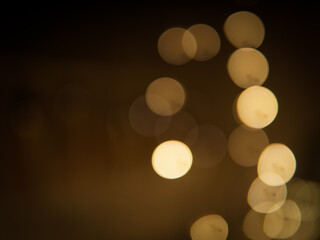Golden and dark brown round bokeh lights festive background