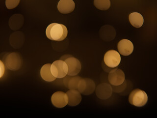 Golden and dark brown round bokeh lights festive background
