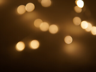 Golden and dark brown round bokeh lights festive background